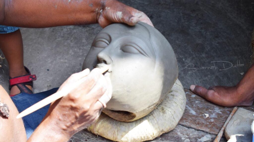 The face of Goddess Durga is being sculpted.